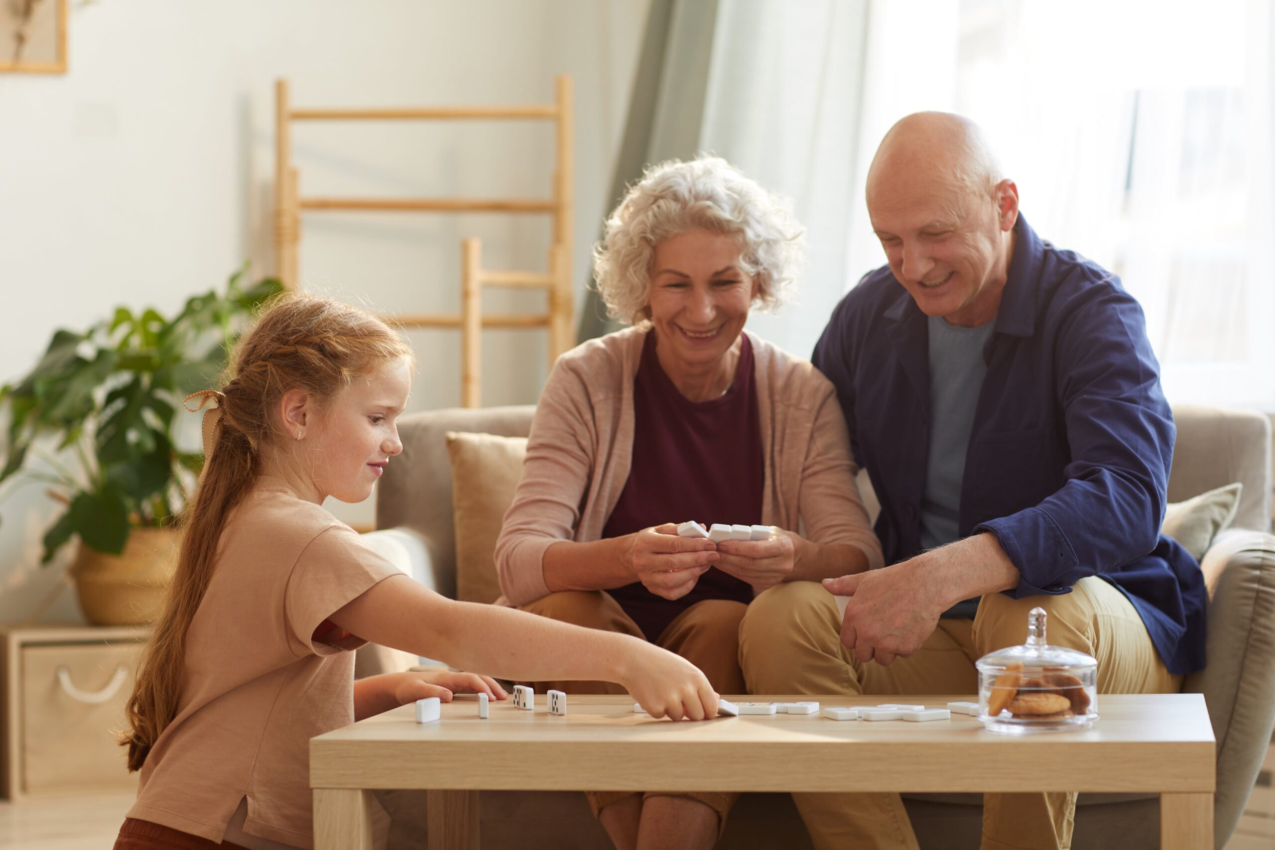 Senior couple and a child playing board game