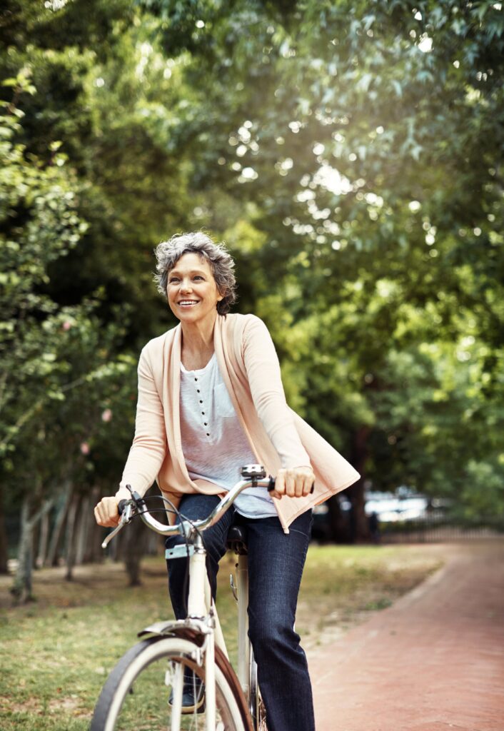 Beautiful smiling woman riding a bike
